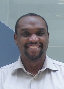 Head and shoulders picture of Dr Dean Dorsett smiling, wearing white shirt
