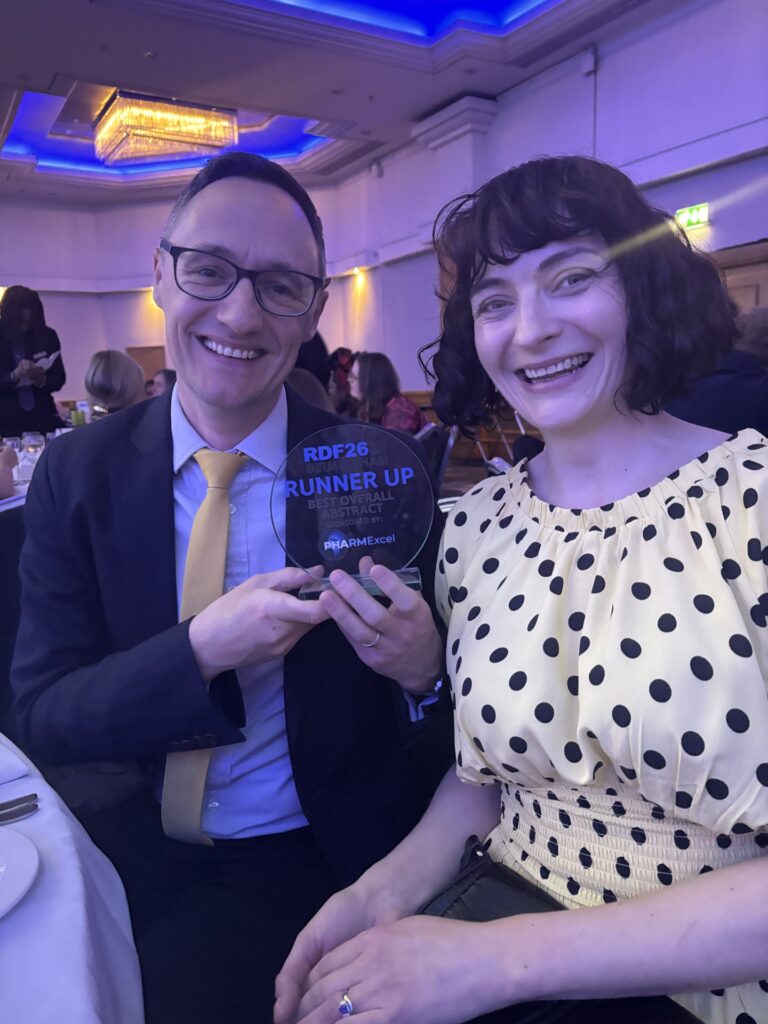 Michael Twigg and Clara Yates with their award