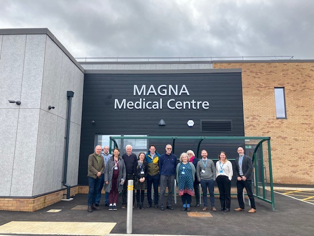 A photo of the Engagement Group outside Magna Medical Centre.
