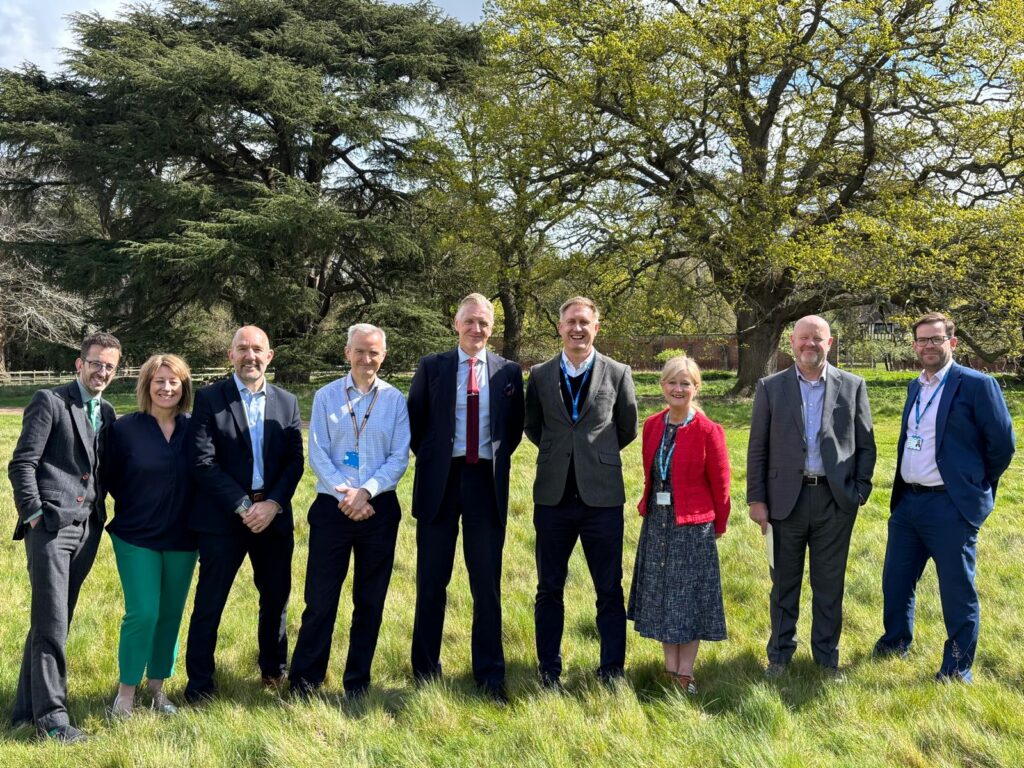 Ed photographed with a group of directors and colleagues at the site of West Suffolk’s new hospital, standing together outdoors during a visit to the development site.