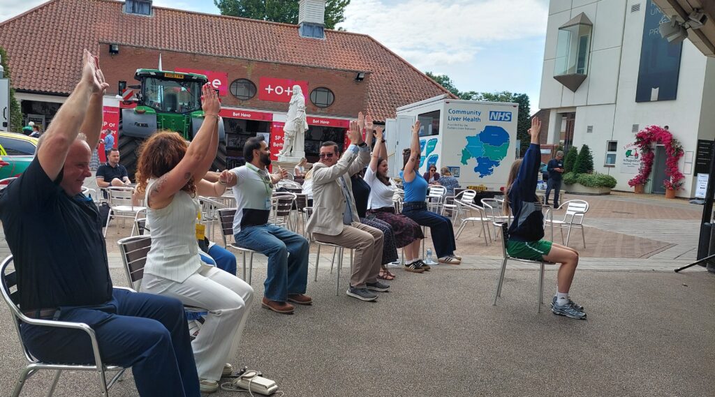 Delegates taking part in the seated yoga session