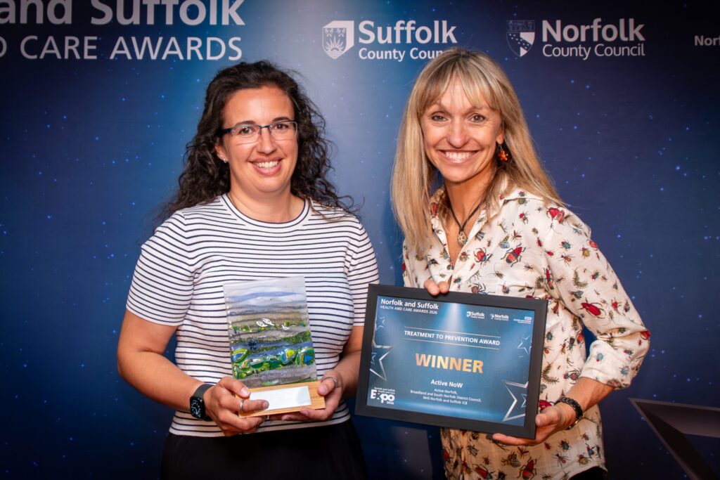 A member of the Active NoW team with the award and Michaela Strachan holding the certificate