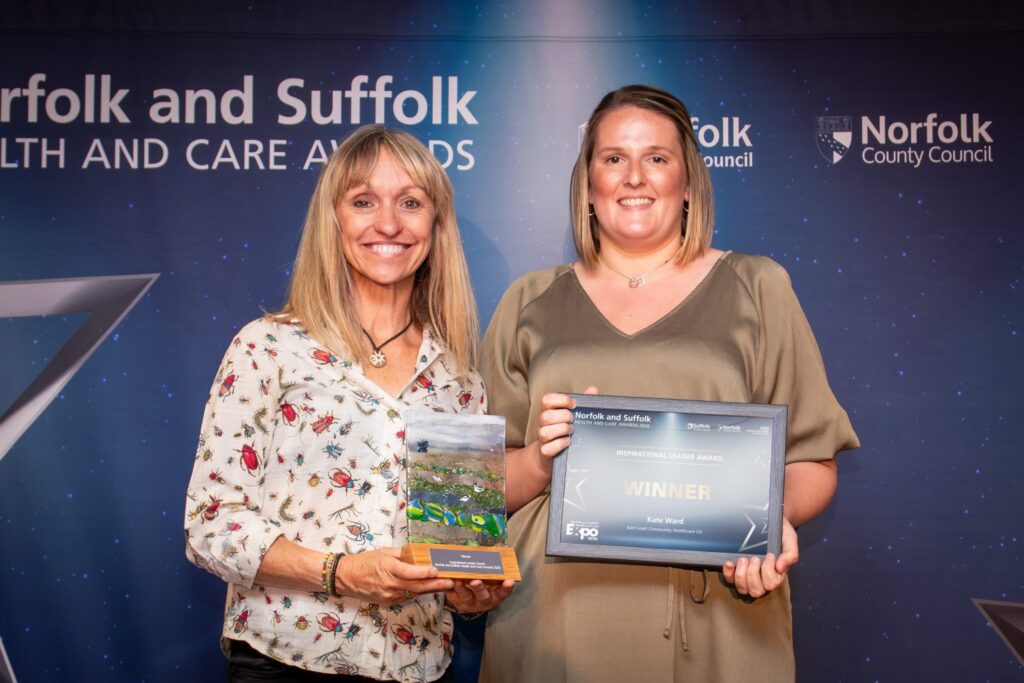 Kate Ward holding her certificate with Michaela Strachan holding the award