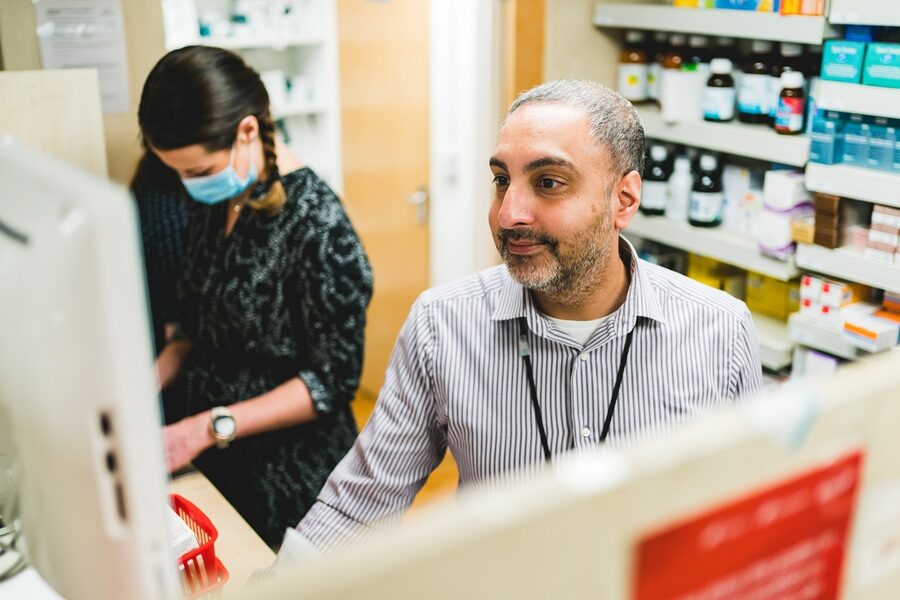 Pharmacy staff at a computer